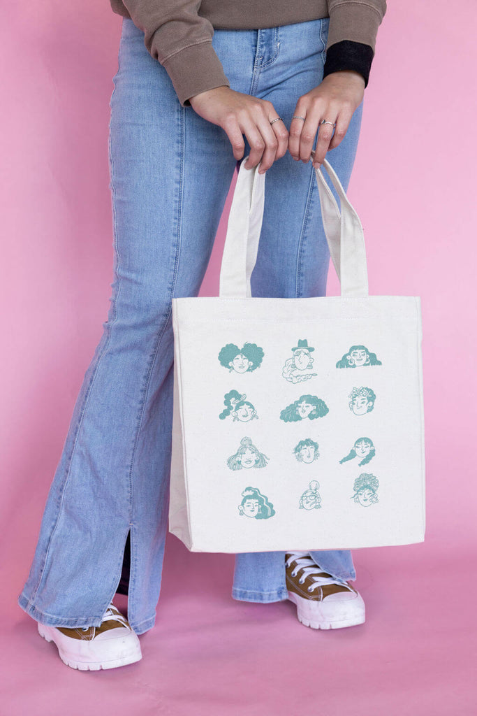 illustration of faces on a cotton tote bag