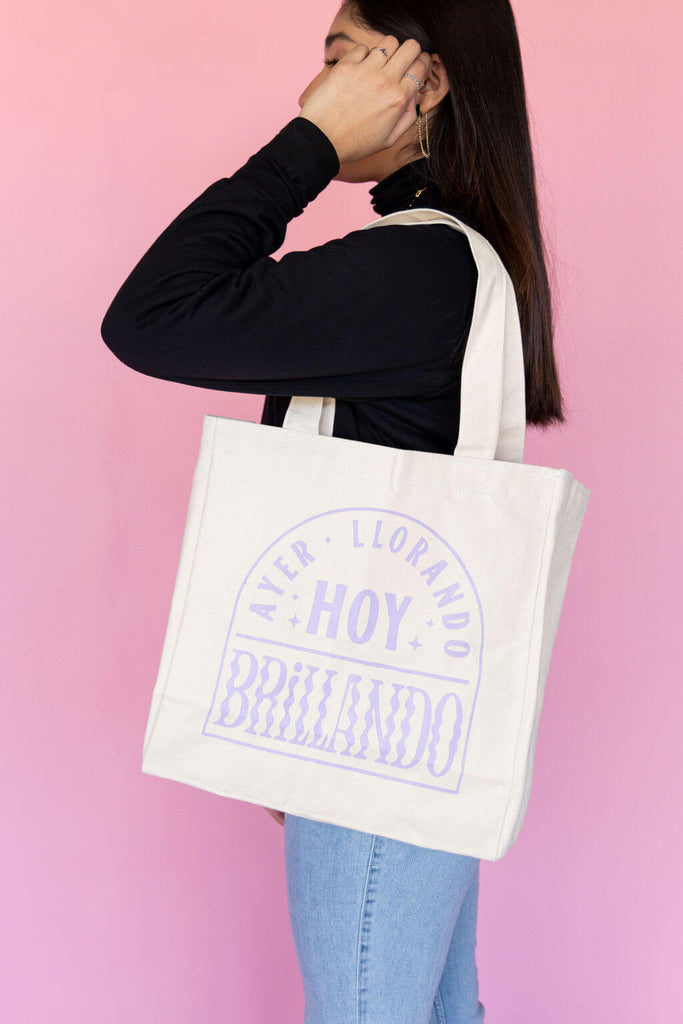 model carrying white tote bag with trendy lilac design